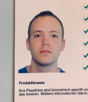 Victor Breidenbach passport picture with checkmarks